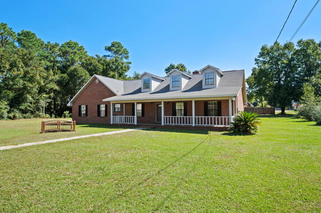 a front view of a house with a garden