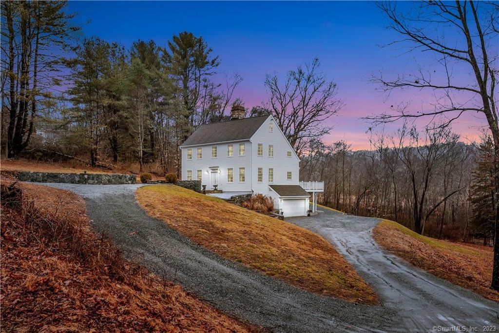 a view of a house with a yard covered in snow