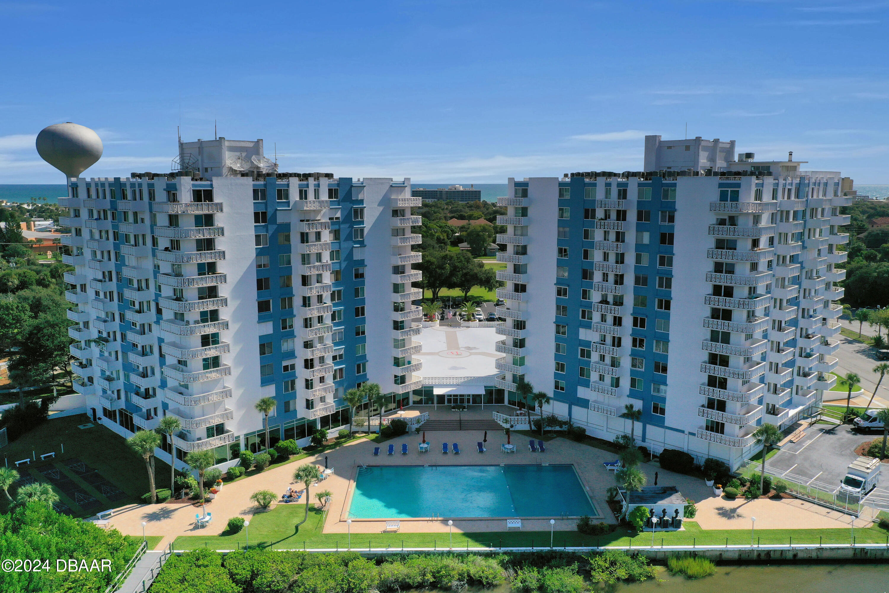 a view of building with yard and swimming pool