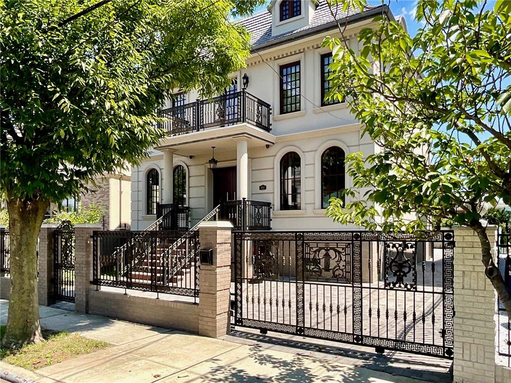 a front view of a house with wooden fence