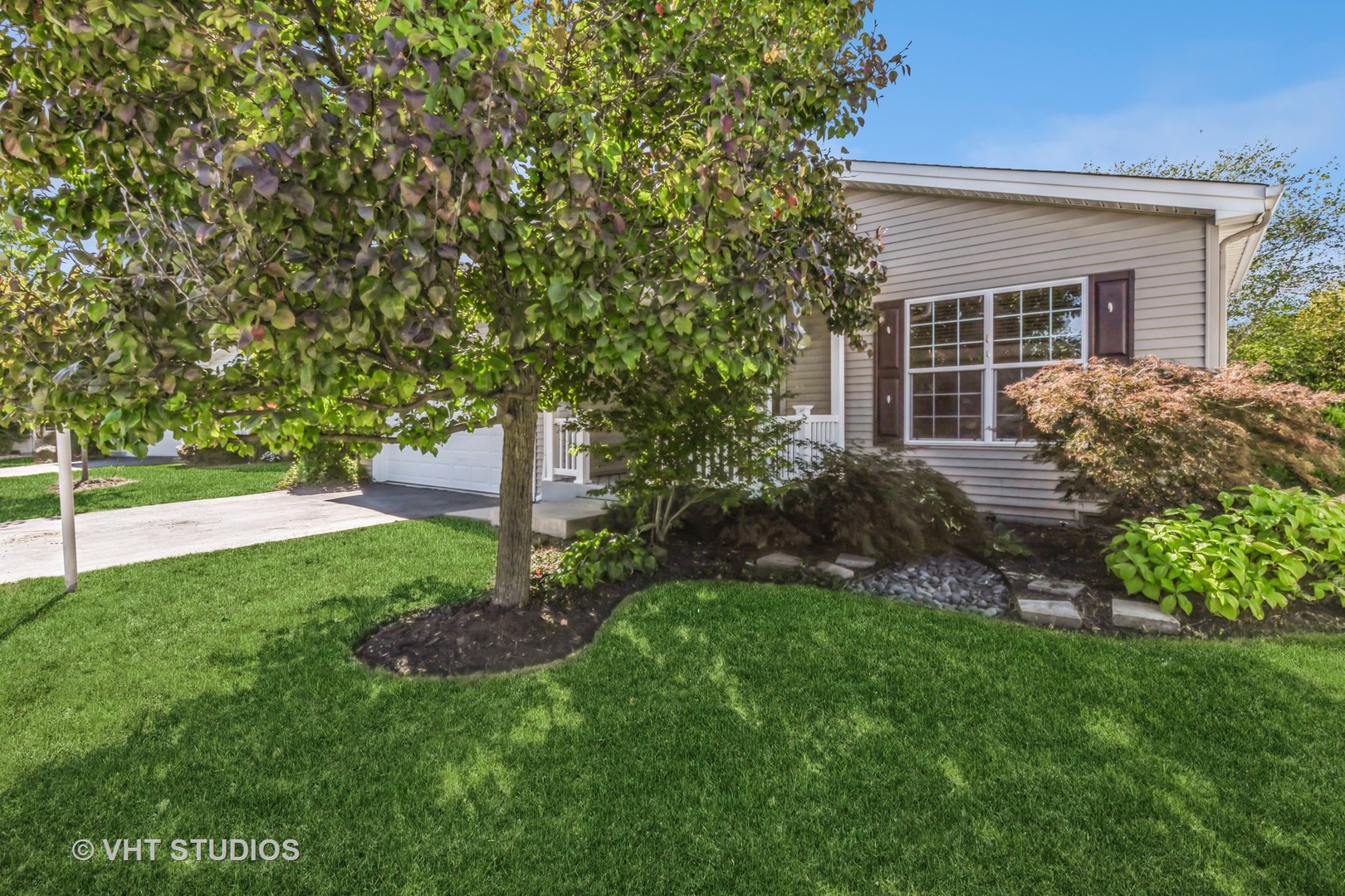 a view of a house with a yard and plants