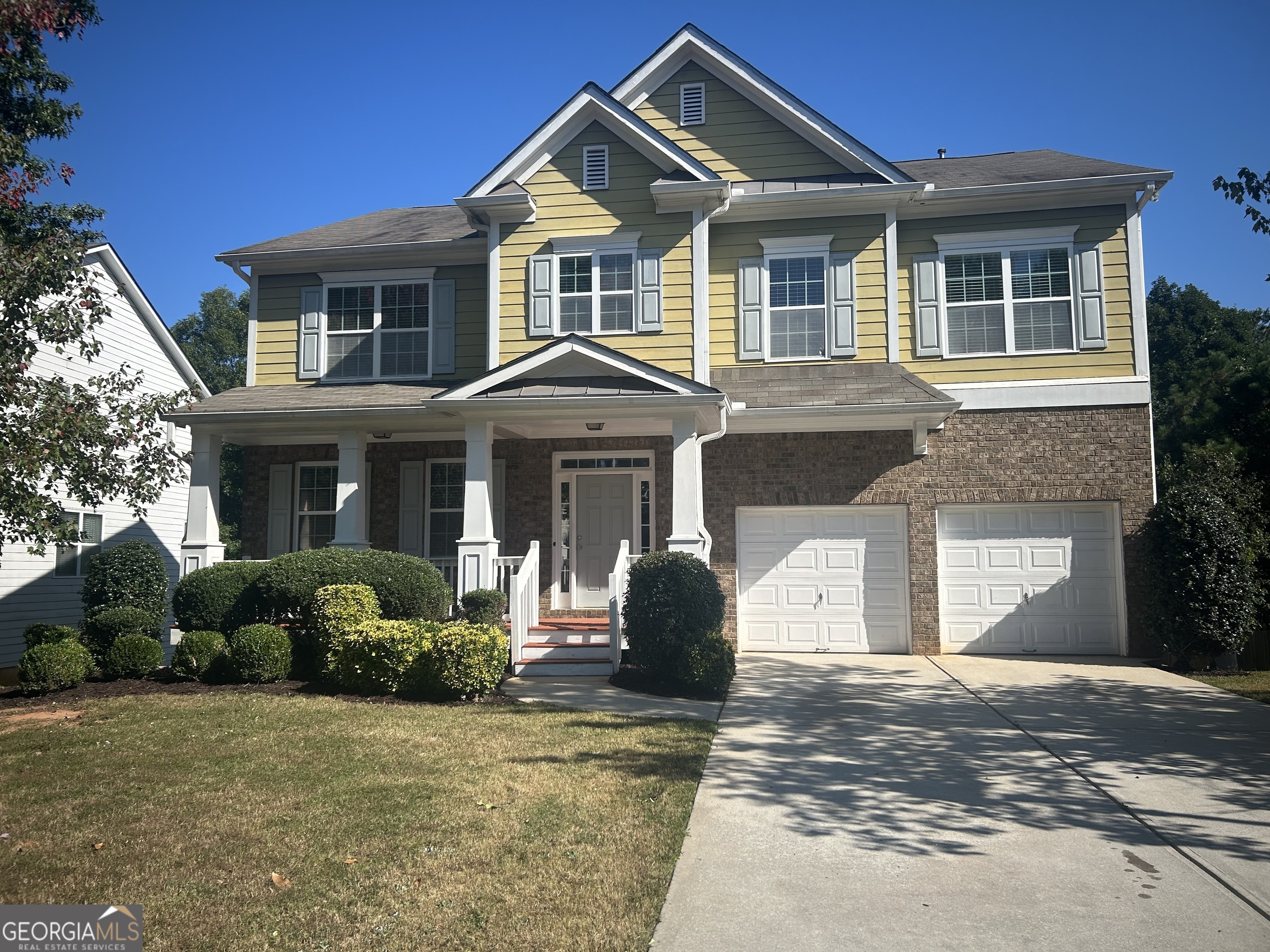 a front view of a house with garden