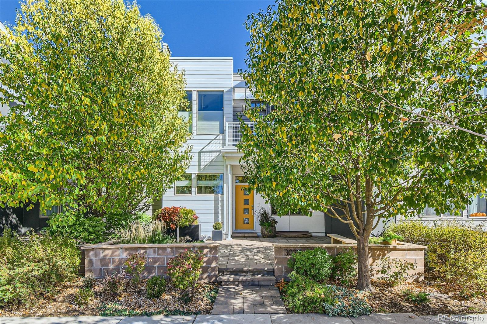 front view of a house with a tree