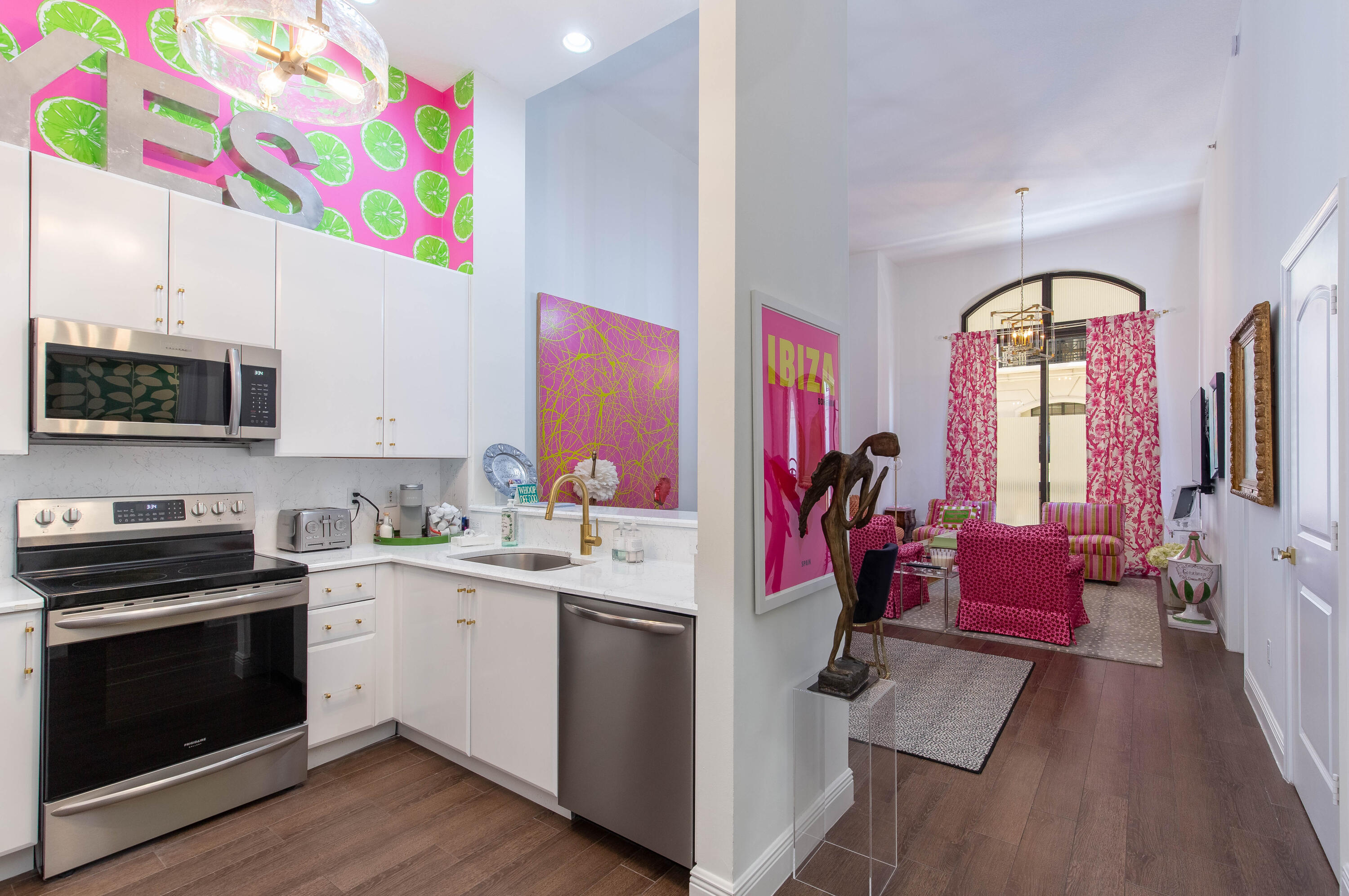 a kitchen that has a lot of cabinets and wooden floor