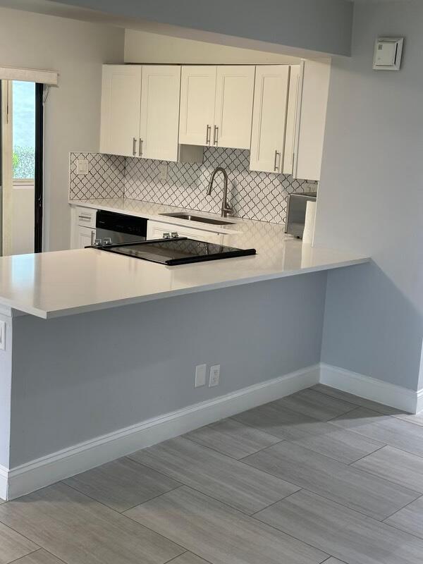 a kitchen with kitchen island a sink stove and wooden floor