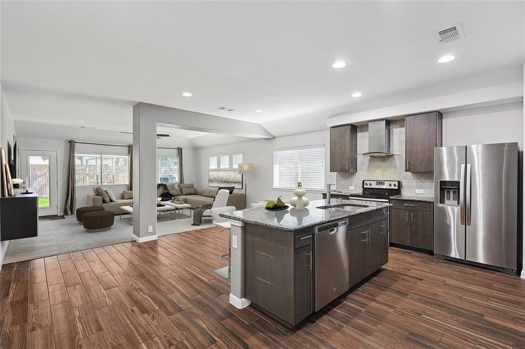 a kitchen with refrigerator and cabinets