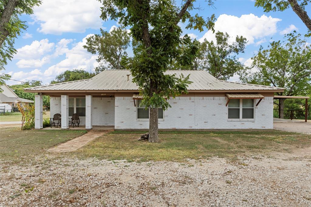 View of front of property with a front lawn and a carport