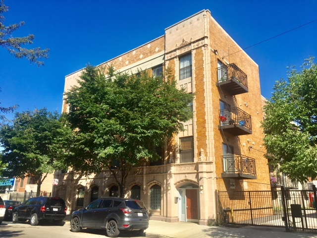 a front view of a building with street view