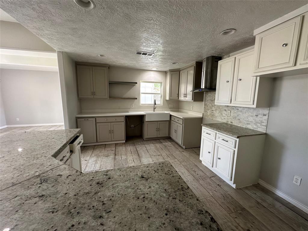 a kitchen with stainless steel appliances granite countertop a sink stove and cabinets