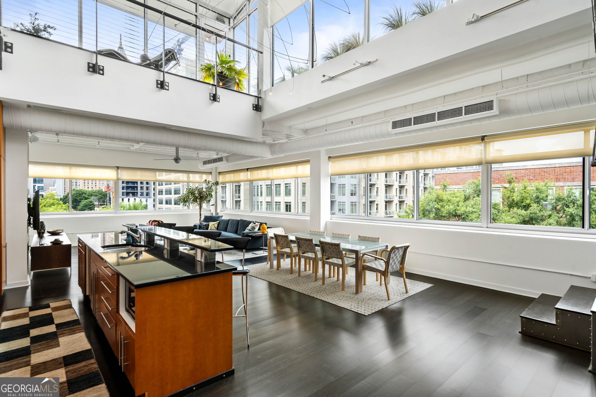 a kitchen with stainless steel appliances granite countertop a stove and a view of living room