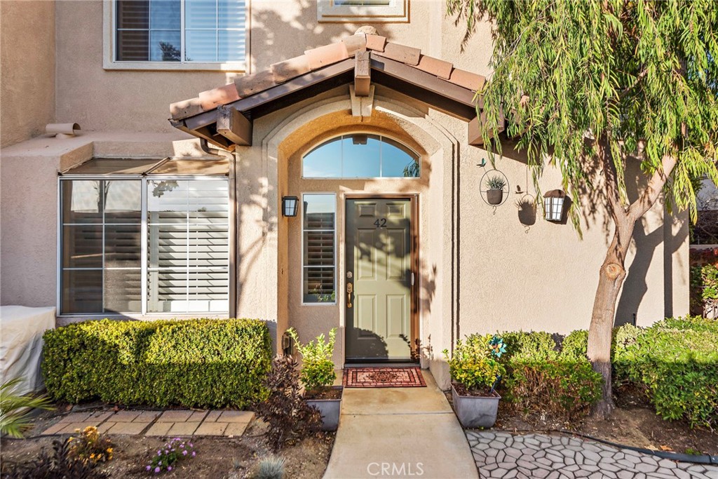 Beautiful gated front courtyard leads to front door.