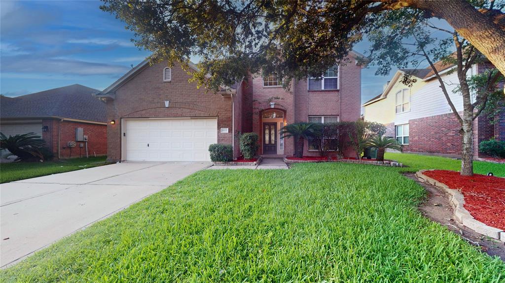 An attached two-car garage, and a welcoming front entrance.