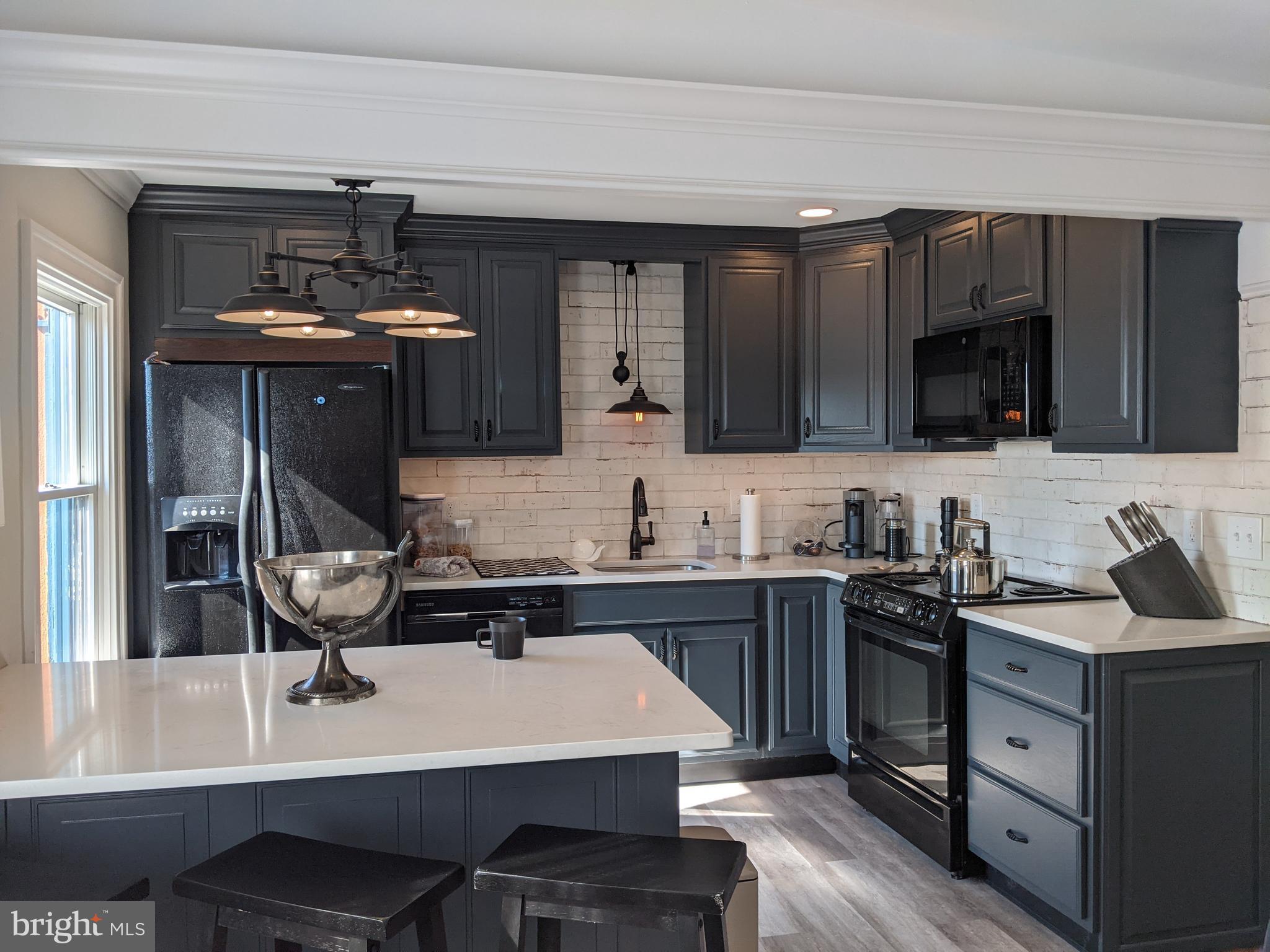 a kitchen with a sink a stove and cabinets