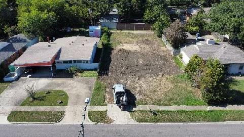 an aerial view of a house with a yard and garden