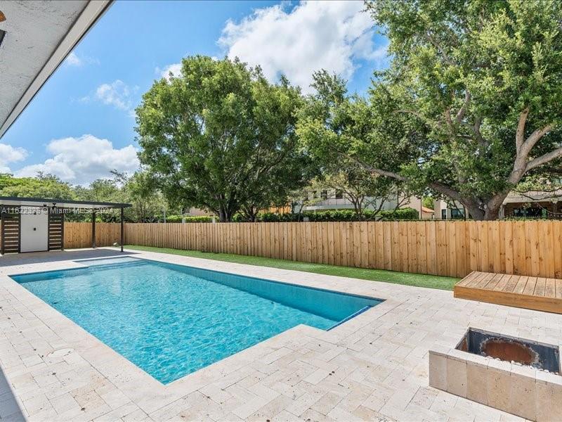 a view of a backyard with swimming pool