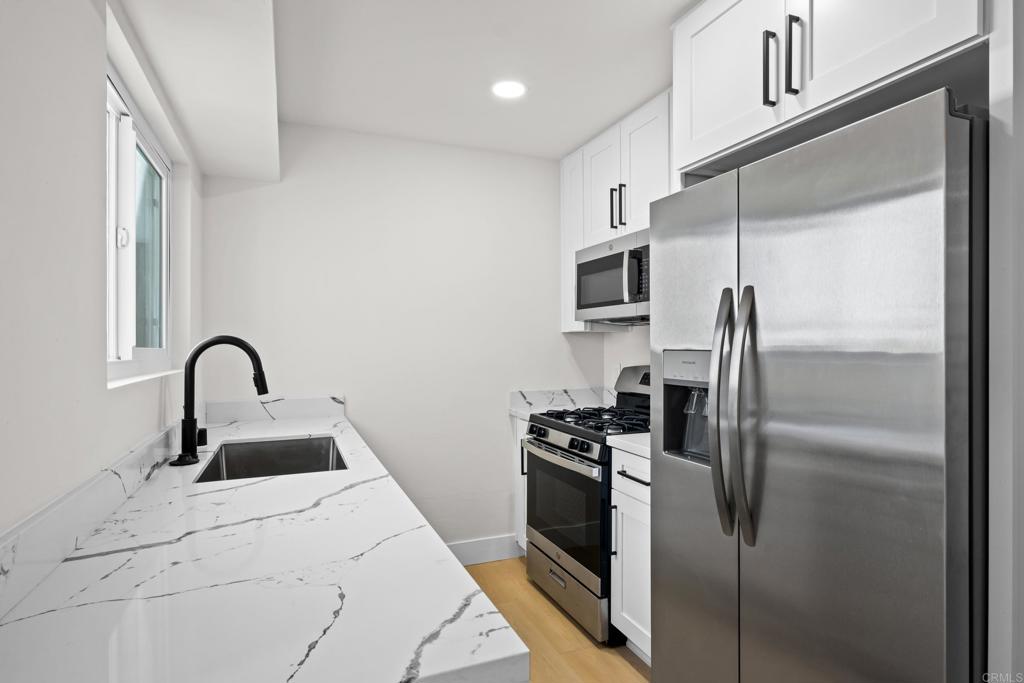 a kitchen with a refrigerator sink and stainless steel appliances