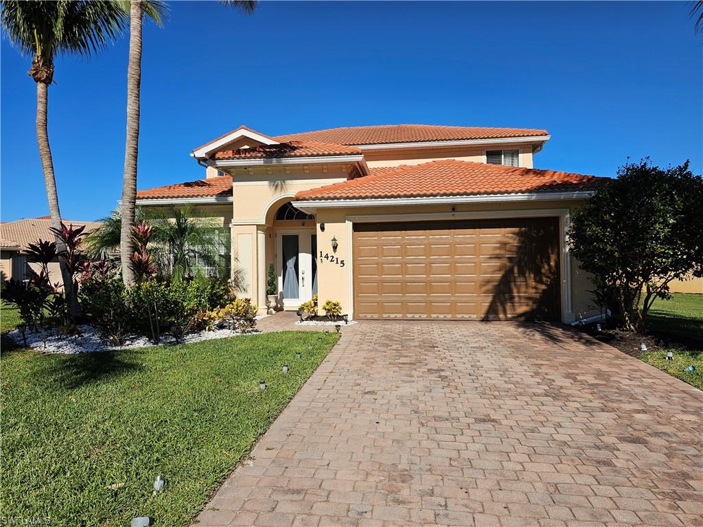 Mediterranean / spanish-style house featuring a front lawn and a garage