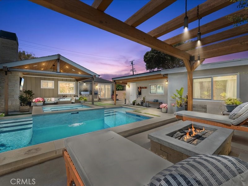 Relax by the firepit after taking a dip in your amazing pool with built in SPA .