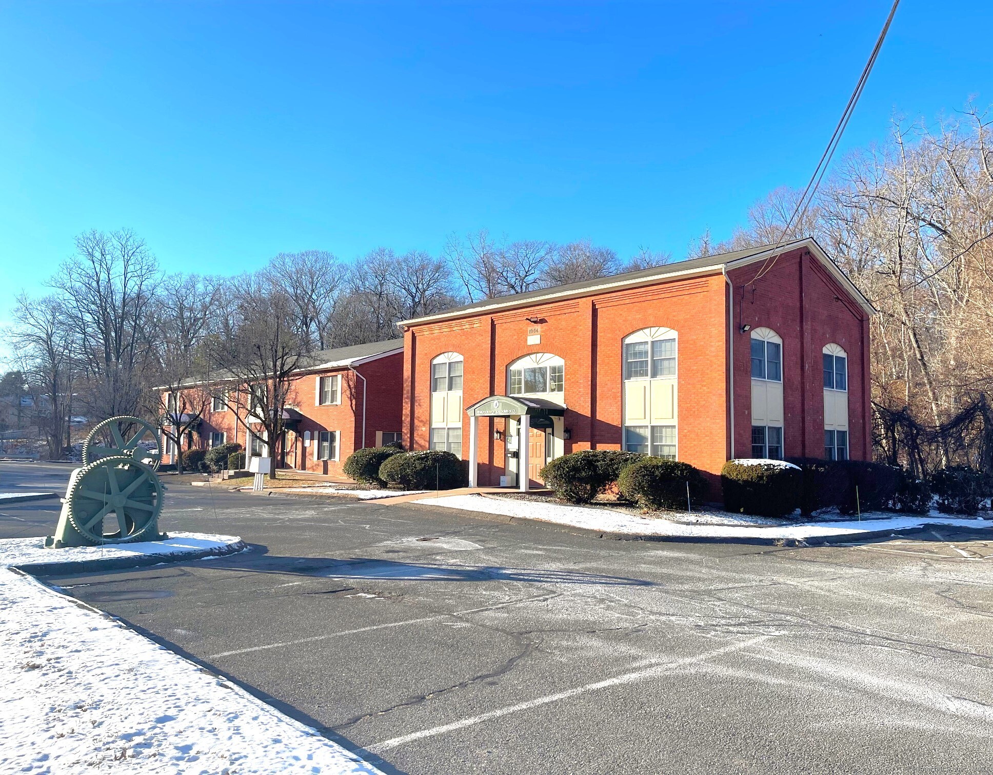 a view of a brick building next to a yard