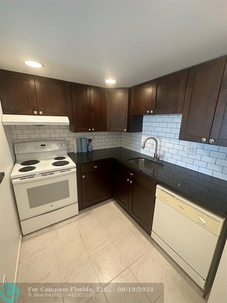 a kitchen with a stove and a sink