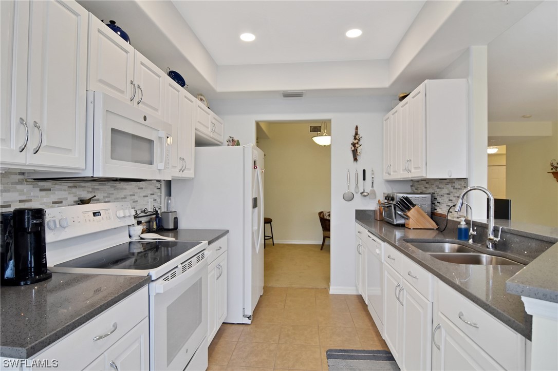 a kitchen with stainless steel appliances granite countertop a sink and cabinets