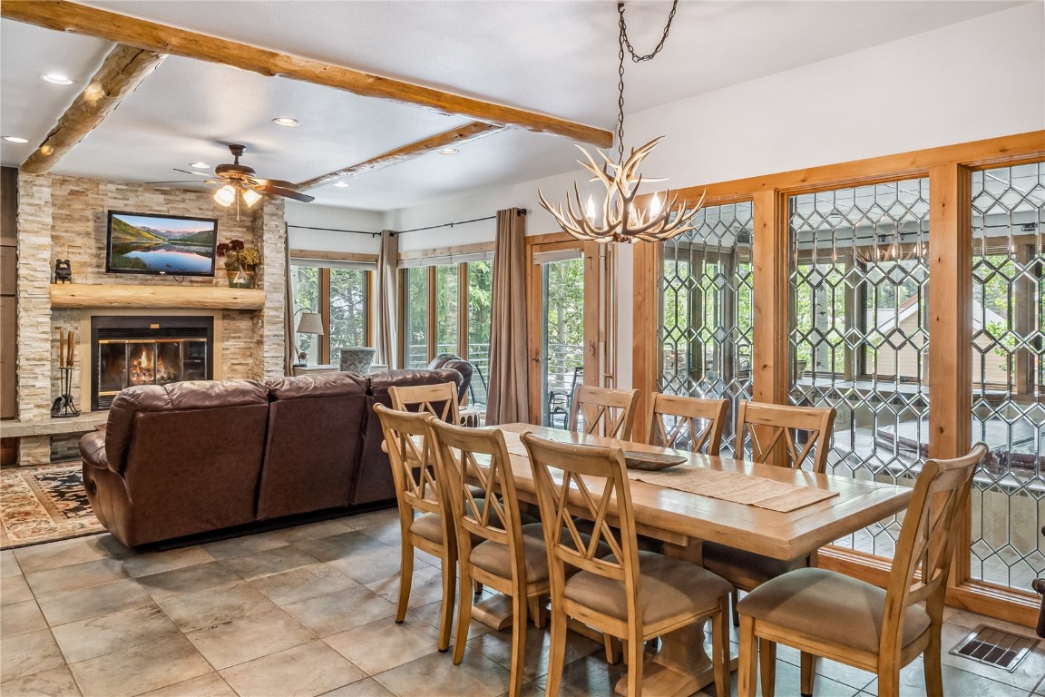 a view of a dining room with furniture large windows and wooden floor