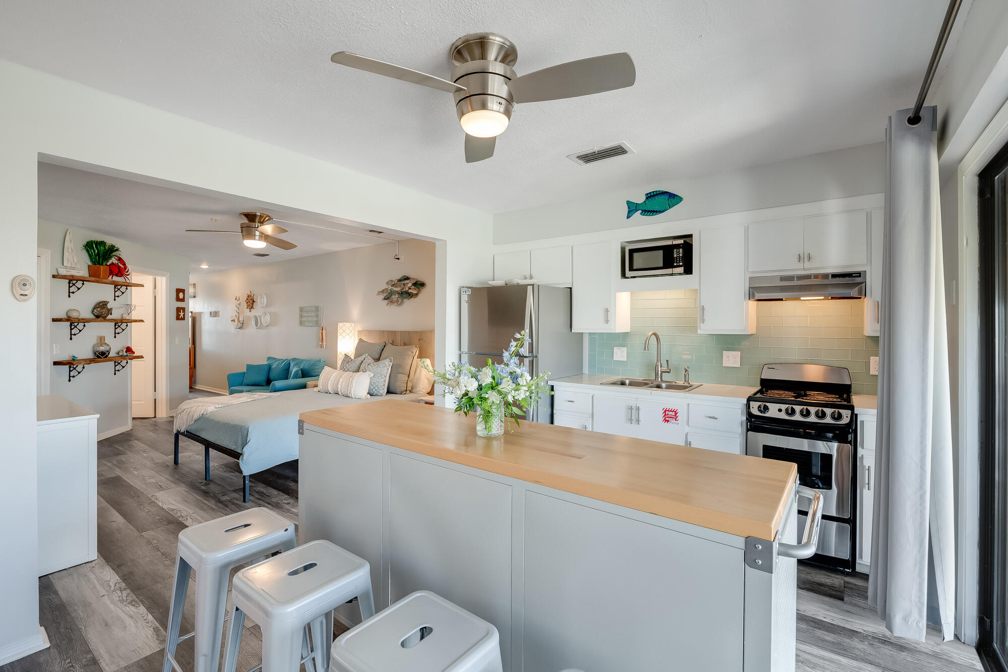 a kitchen with a sink appliances and cabinets