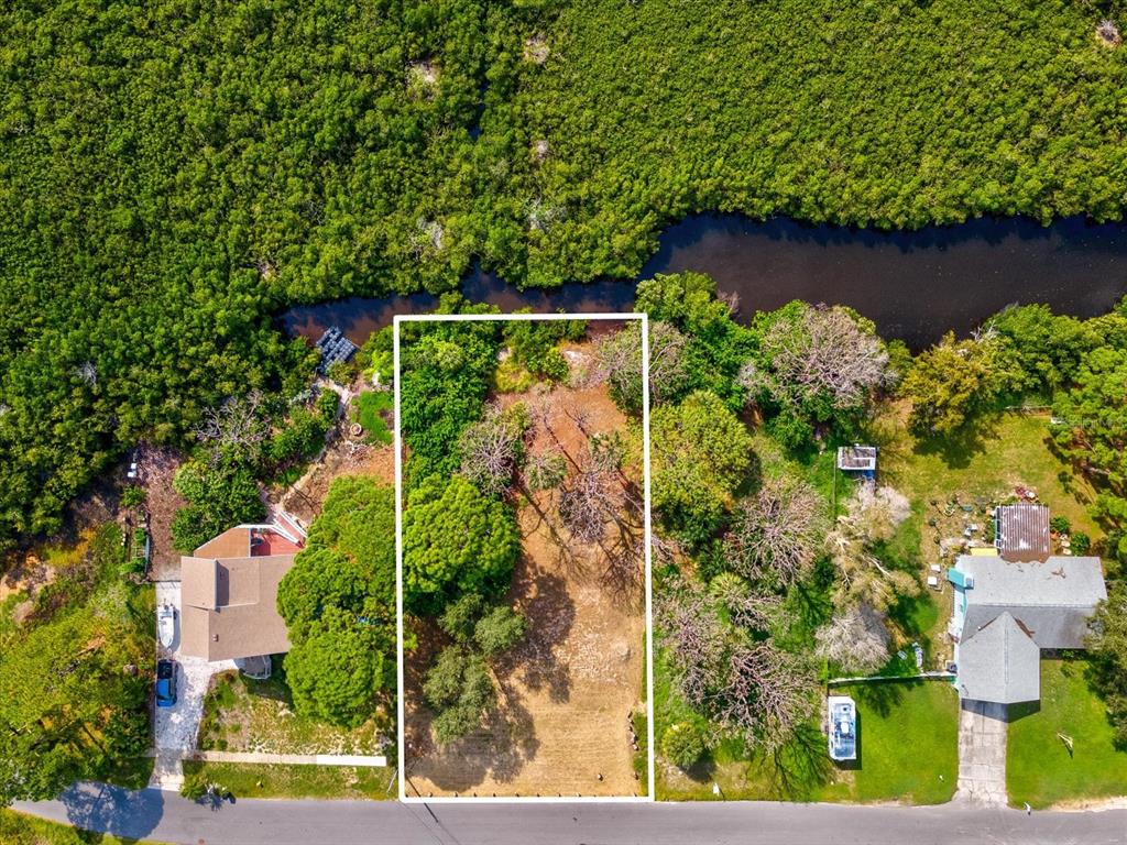 an aerial view of house with yard swimming pool and outdoor seating