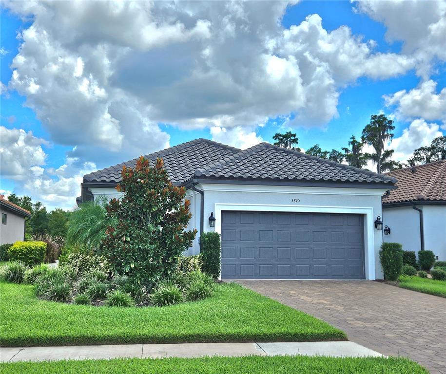 a front view of a house with a yard and garage