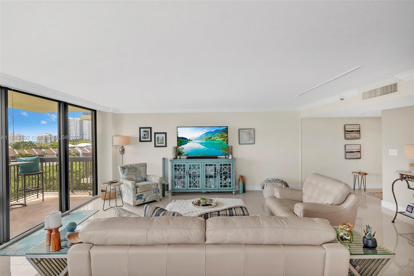 a living room with furniture and a flat screen tv