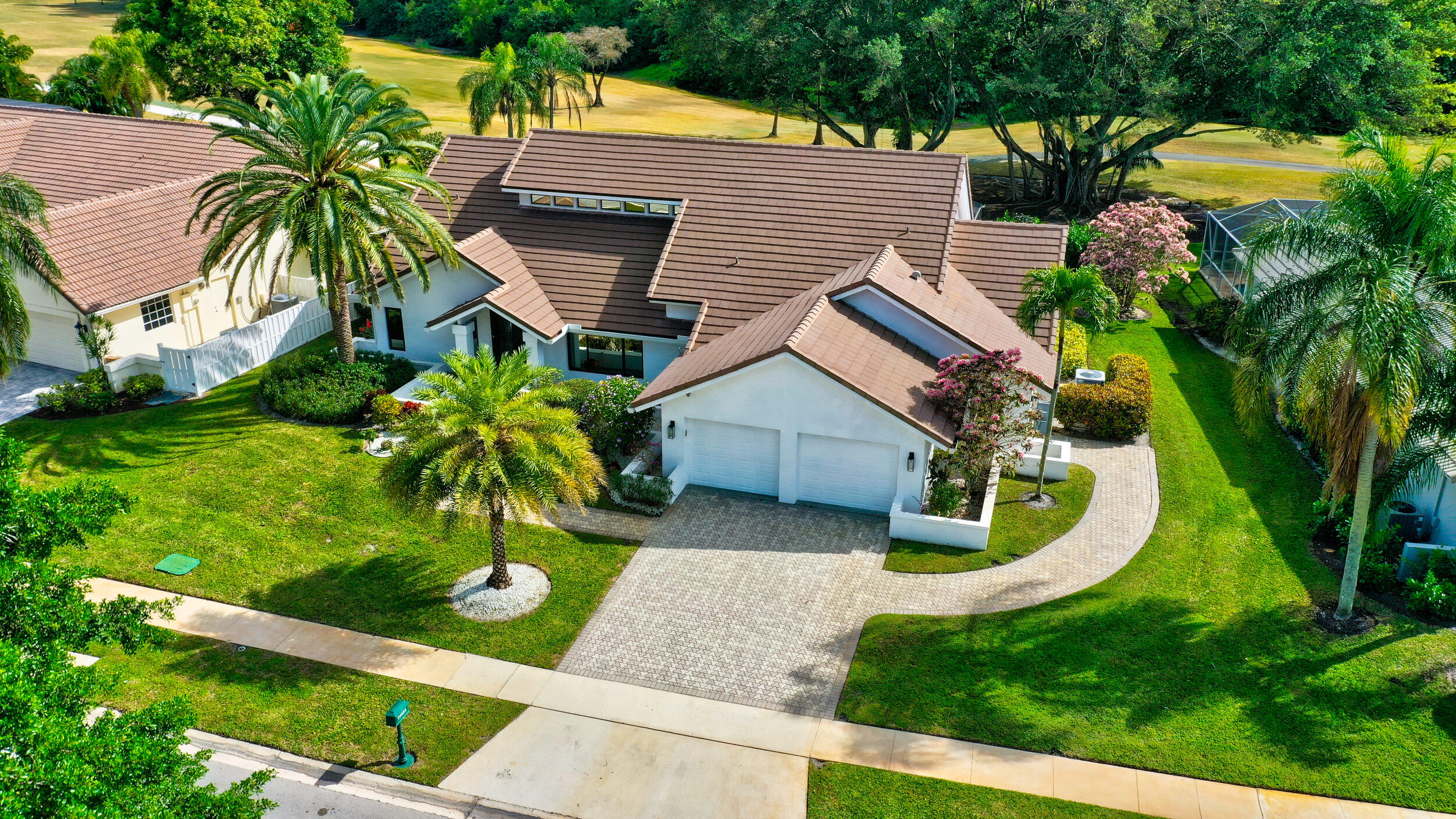 a view of a house with a yard and potted plants