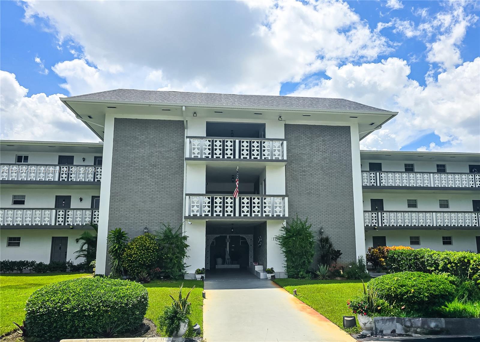 a front view of a building with garden