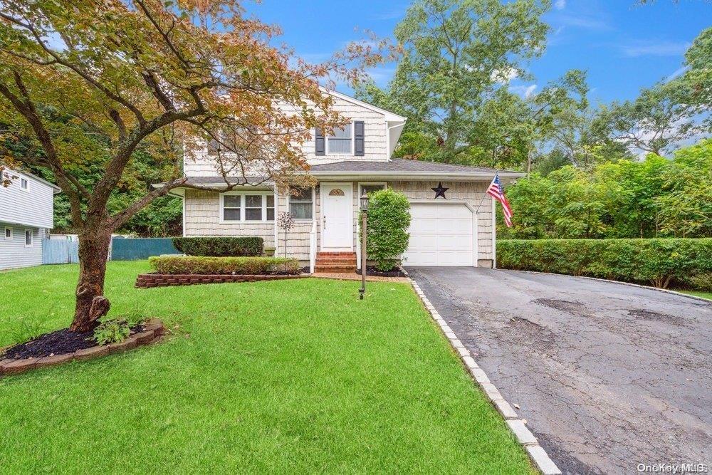 a front view of house with yard and green space