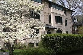 a view of a white house with large windows