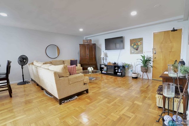 a living room with furniture and a mirror