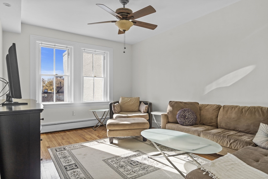 a living room with furniture a rug and a window