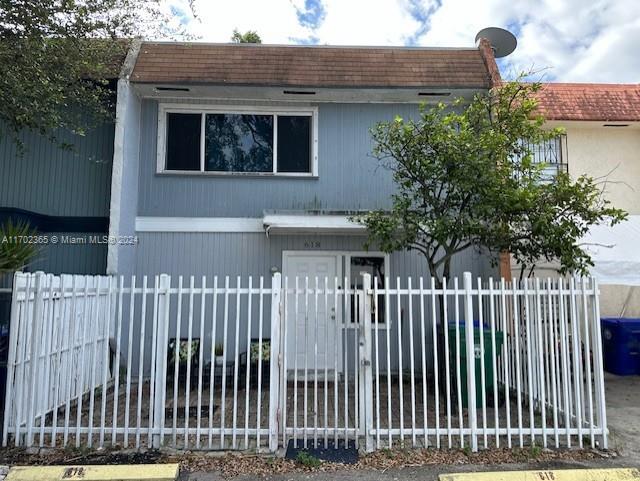 a front view of a house with a fence