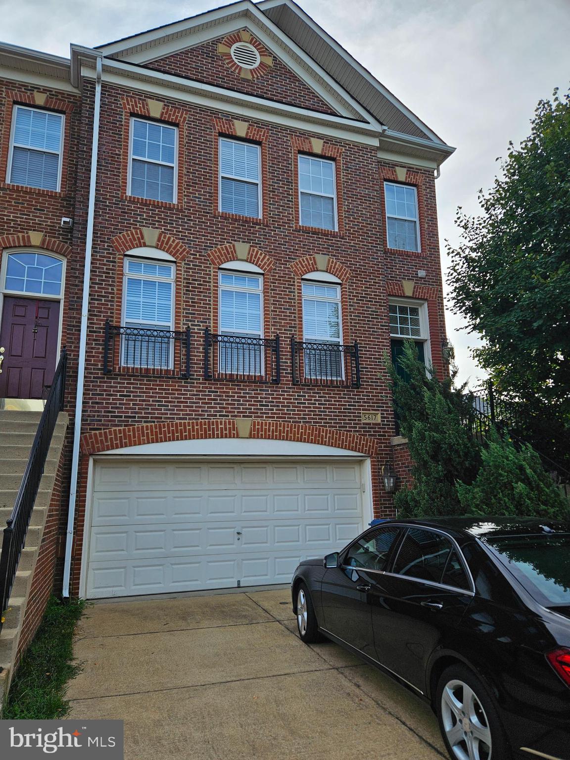 a front view of a house with parking space