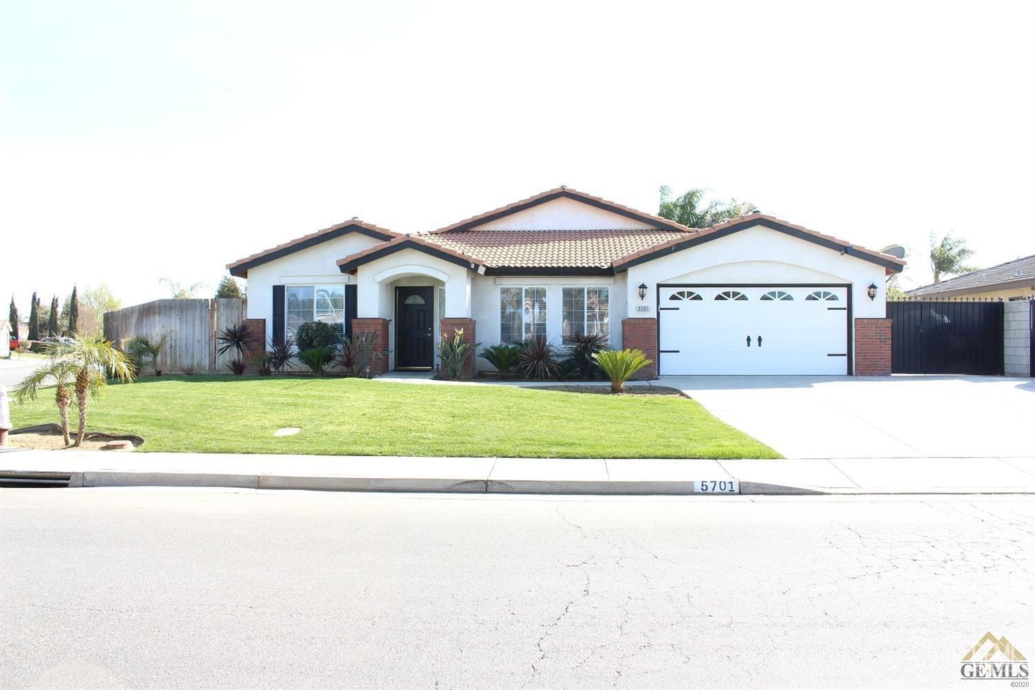 a view of house with a big yard and potted plants