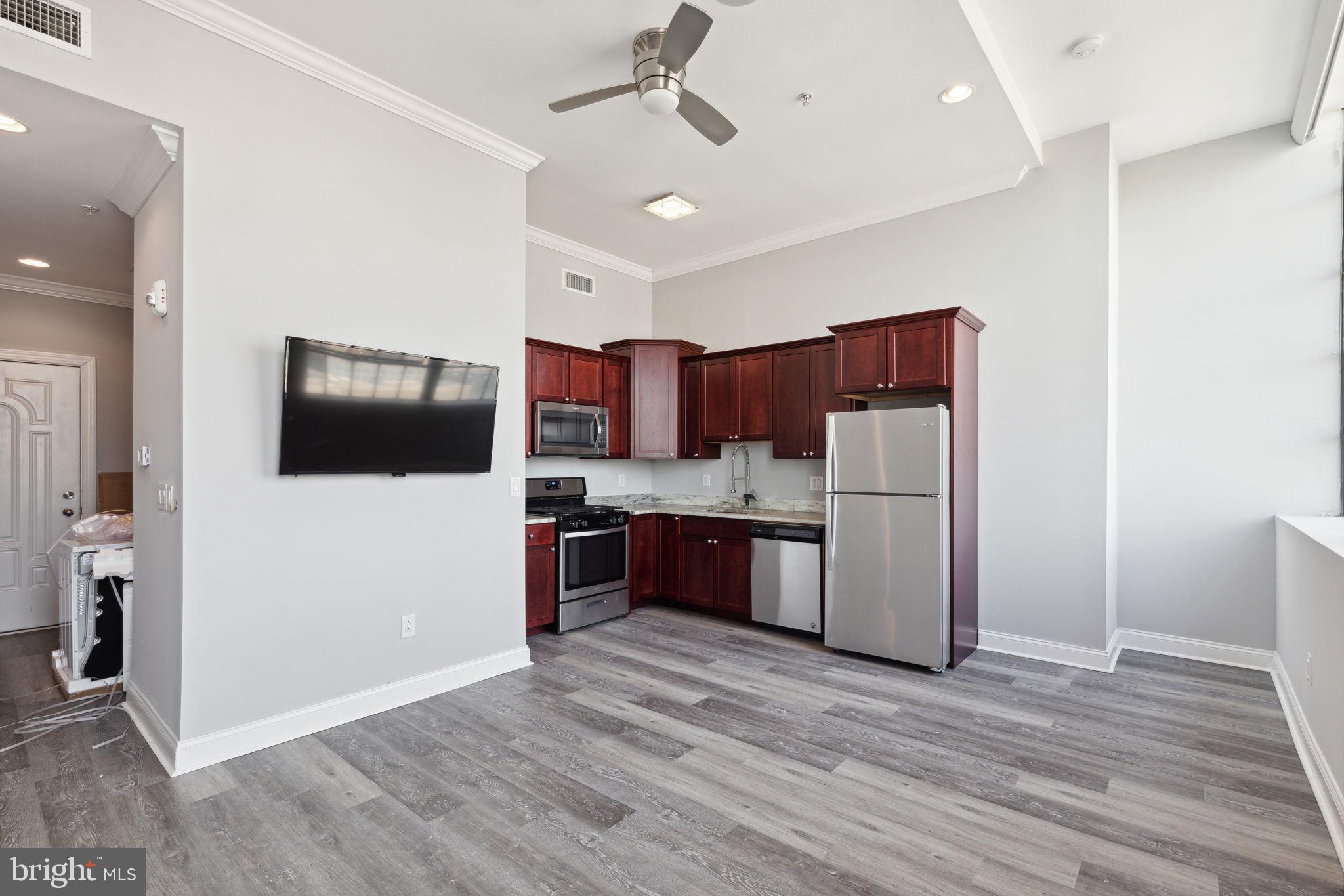 a kitchen with stainless steel appliances a refrigerator and a stove top oven