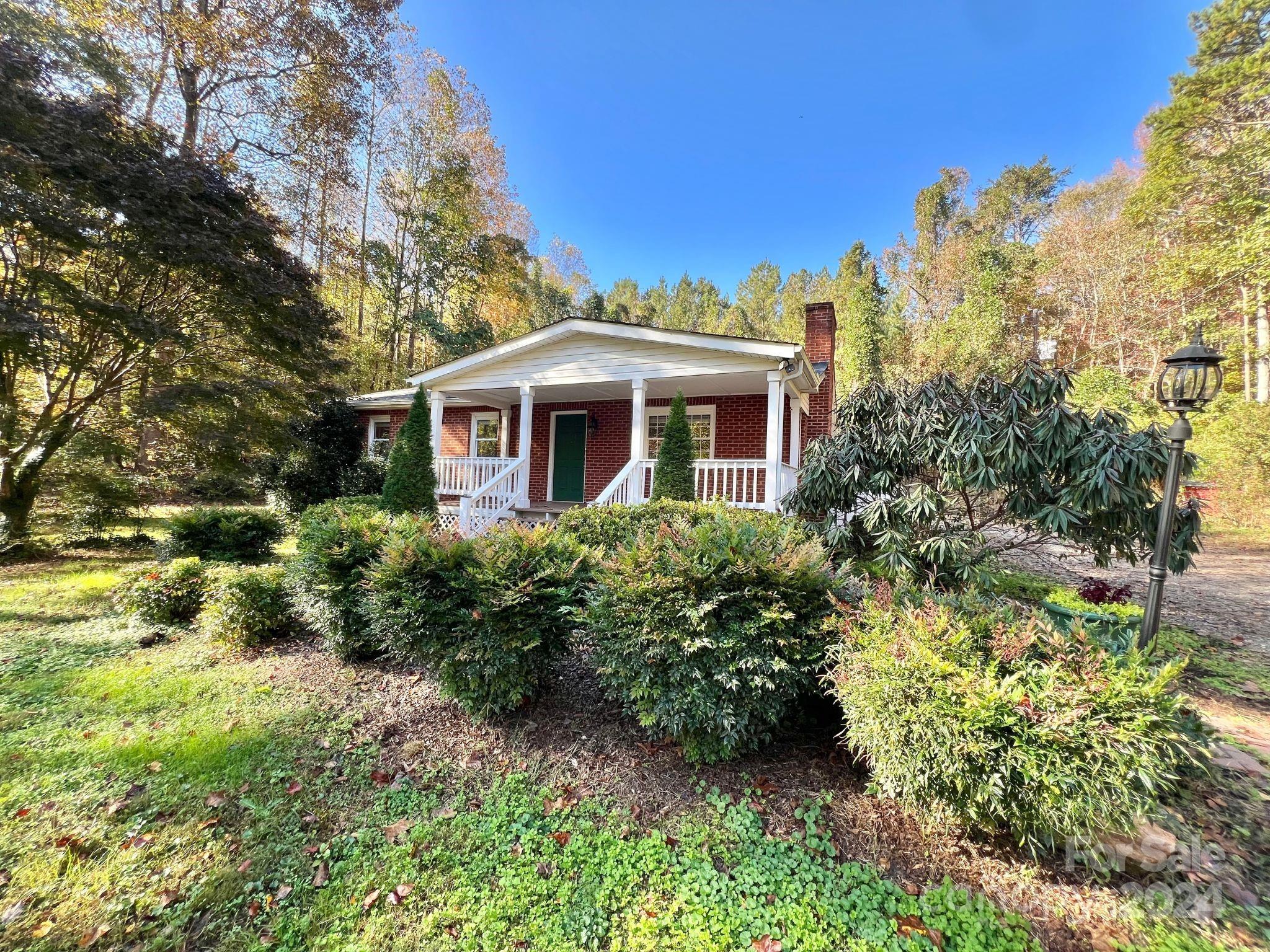 a view of a house with a yard and garden