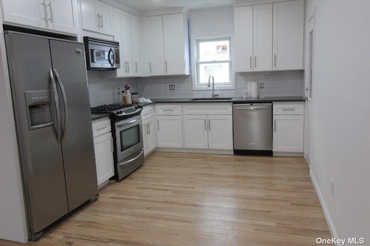 a kitchen with stainless steel appliances granite countertop a refrigerator sink and stove