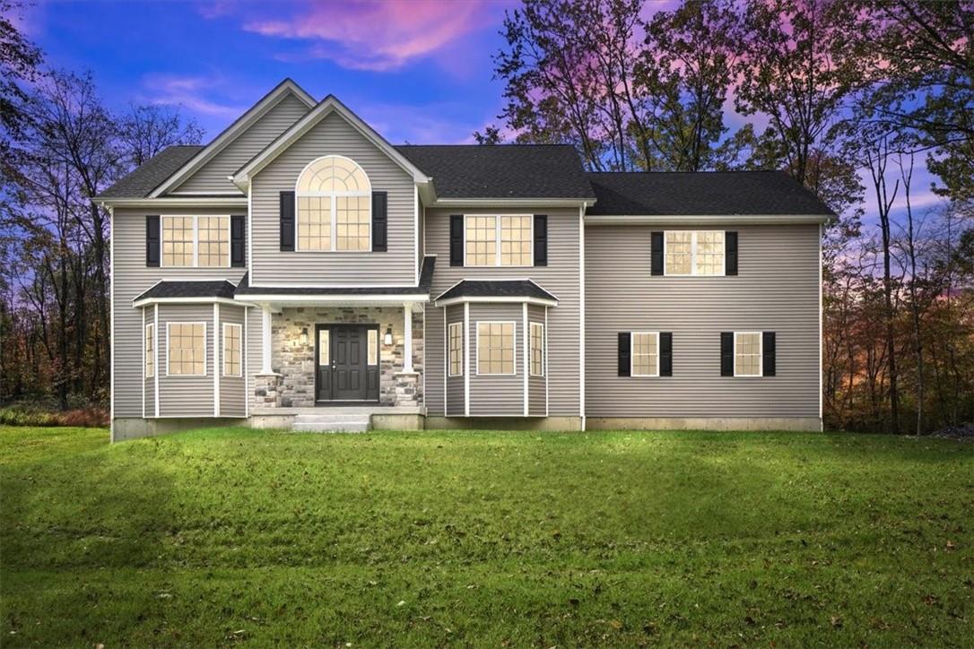 View of front of home with a lawn