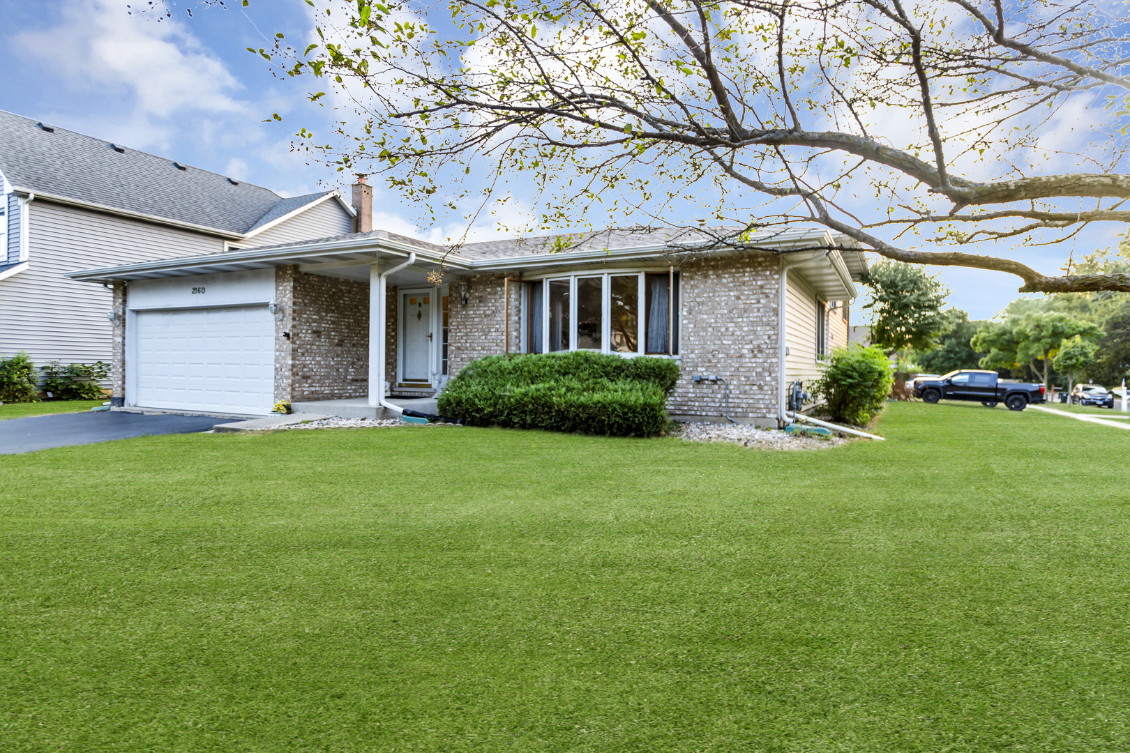 a front view of a house with a garden