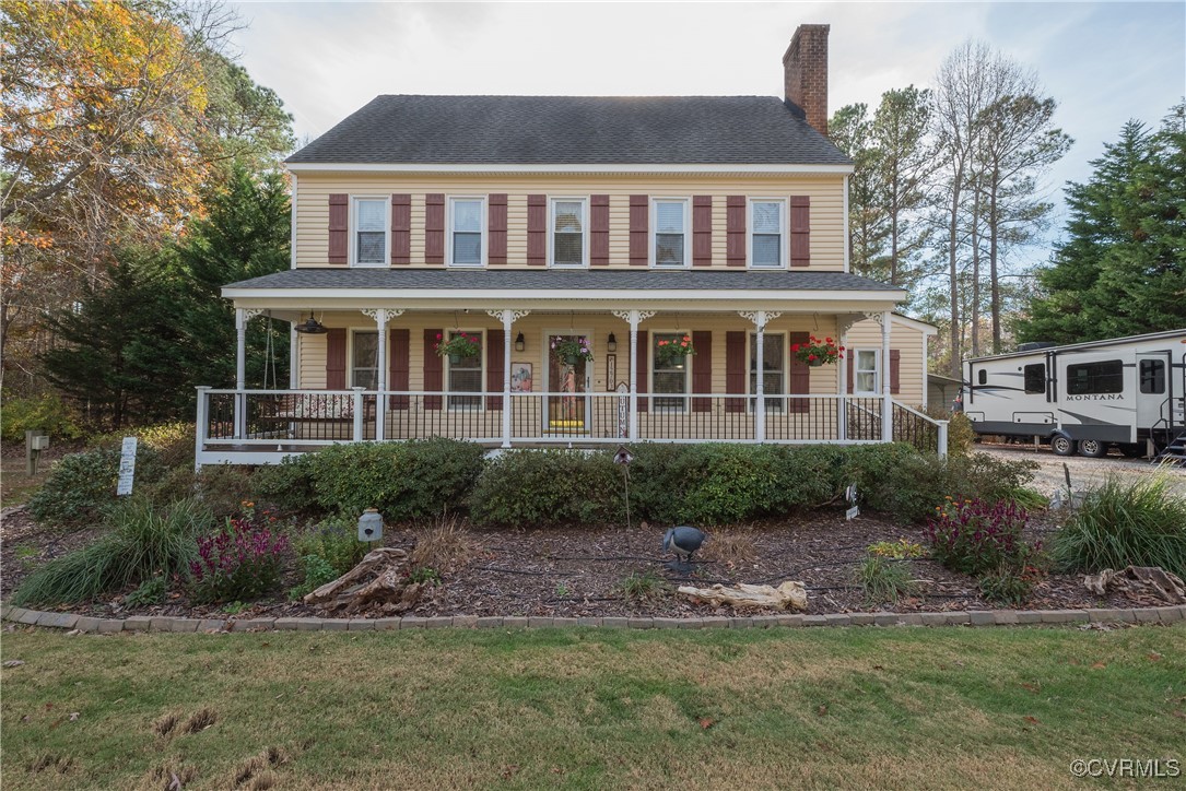 Colonial-style house with covered porch and a fron