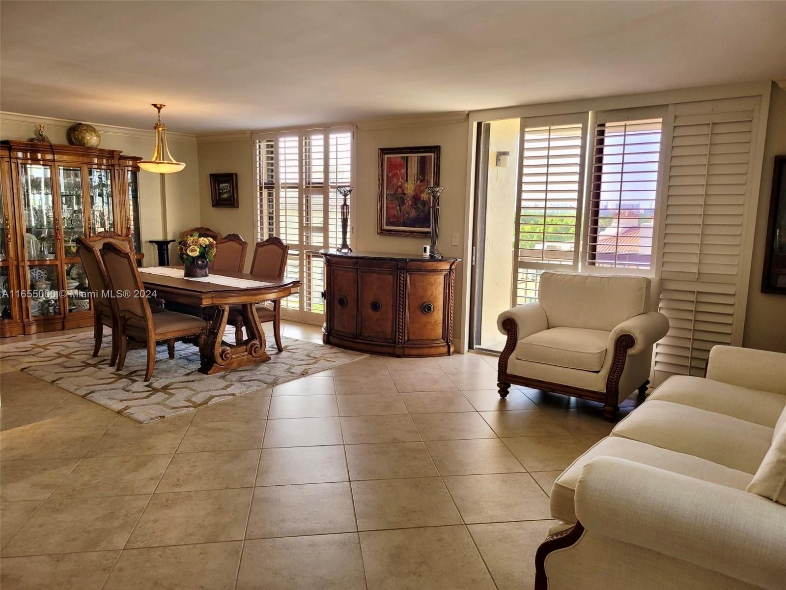 a living room with furniture a dining table and a window