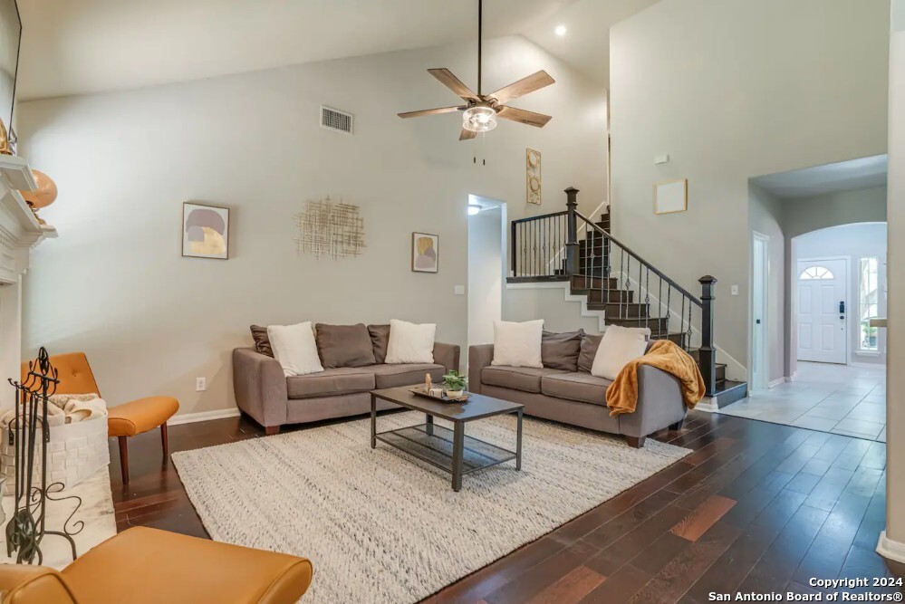 a living room with furniture and a wooden floor