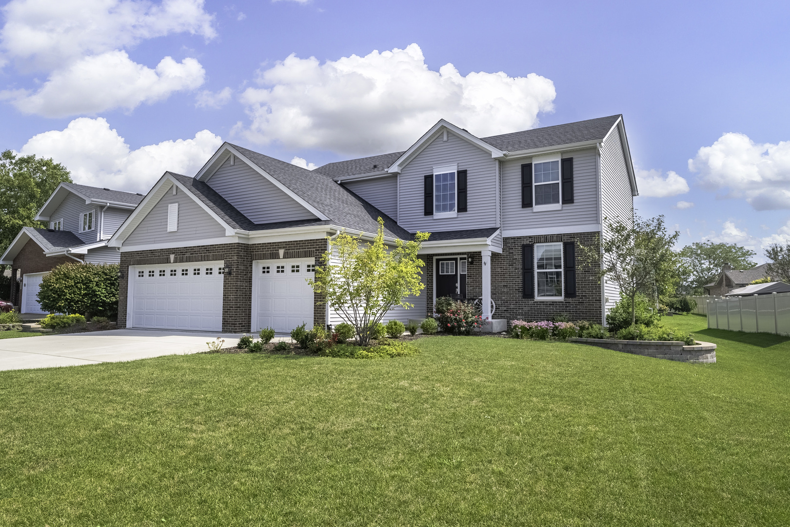 a view of a house with a yard and pathway