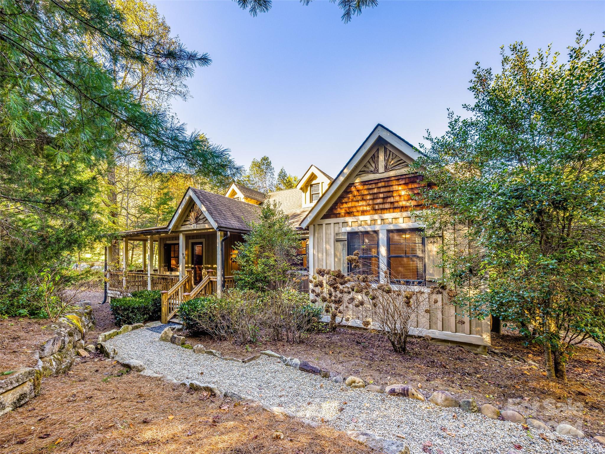 a front view of house with yard and trees around