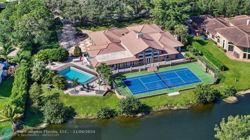 an aerial view of a house with a garden and lake view